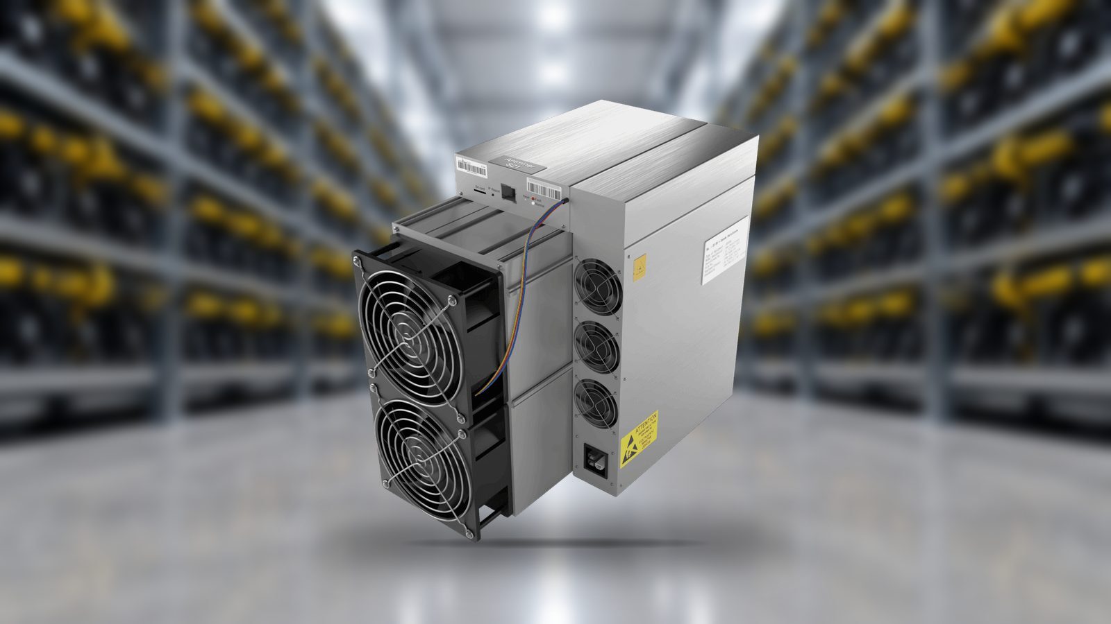 A Bitmain Antminer S21 photographed whole in front of a softly blurred air-cooled mining hall with racked machines and a polished concrete floor